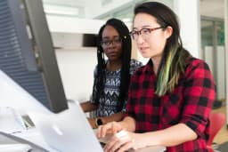 Two people collaborating on web development